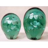 Two Victorian green glass dumps, possibly Stourbridge with potted flower inclusions, 13cm & 11cm