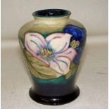 A William Moorcroft Clematis pattern vase, pre 1950, of baluster form on a blue/green wash ground,