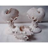 Two late 19th century Belleek porcelain shell vases, with naturalistic modelled stems and circular