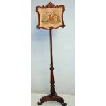 An early Victorian mahogany pole screen with carved rectangular shaped frame enclosing tapestry of