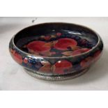 A Moorcroft pottery Tudric fruit bowl of shallow circular form with planished pewter foot,