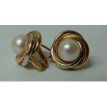 A pair of 18ct gold and single pearl earrings in swirl mounts, hinged stud mount, each cultured