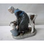 A Royal Copenhagen figure of a Milk Maid with a Calf, number 779, 16cm high