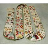 A 19th century needlework sampler bearing crests, animals and flowers etc, 25ft long by 9inches wide