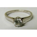 A platinum and diamond solitaire ring, the brilliant cut stone approx 0.6 carat in 8 claw setting,