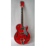 An electric guitar signed Gretsch with Bigsby tremolo, lacquered amber