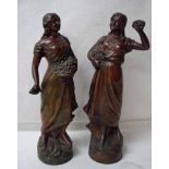 A pair of 19th century French patinated spelter figures of a female flower seller, 29cm high