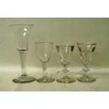 A tall mid 18th century wine glass, drawn type into a thistle shaped bowl, clear stem, heavy foot,