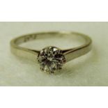 A platinum and diamond solitaire ring, the brilliant cut stone approx 0.6 carat in 8 claw setting,