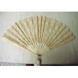 A Chinese ivory and silk Brise fan, the pierced guards and sticks supporting a foliate designed