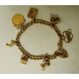 A 9ct gold charm bracelet set with seven 9ct gold charms including a Victoria 1900 gold sovereign,