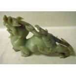 A Chinese carved jade sculpture depicting a mythical dragon dog with a scorpion on its back, 29cm