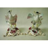 Royal Crown Derby, a pair of bone china Chelsea birds set on floral encrusted Rococco style bases,