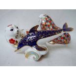 Three Royal Crown Derby bone china paperweights modelled as a dolphin, 18cm long, a seal, 12cm