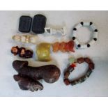 A collection of ten Chinese jade/hardstone buckles, fertility symbols, ornaments and bracelets,