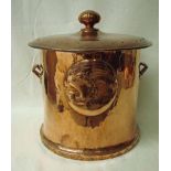 A large Arts and Crafts copper coal bin of lidded, two-handled cylindrical form, embossed with