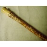 An Oriental carved bone walking stick constructed in nine sections and decorated with dragons and