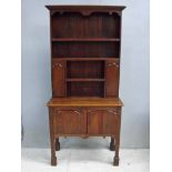A 19th century oak dresser of small proportions, two tier, the upper section with moulded cornice