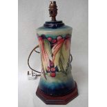 A Moorcroft pottery table lamp base, tubeline decorated in the Leaf and Berries pattern on a