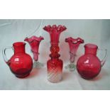 A small collection of cranberry glass including a pair of wavy edge trumpet vases, 16cm high, a wavy