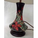 A modern Moorcroft pottery table lamp, tubeline decorated in an Aquilegia style design on a wooden