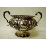 A George IV Regency silver two-handled sucrier, of typical cylindrical form, embossed with