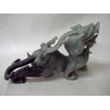 A Chinese carved jade sculpture depicting a mythical dragon dog and scorpion, 32cm