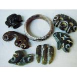 A collection of seven Chinese Hongshan jade/hardstone carved bangle and stylised devices 4.5cm to