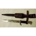 A German Third Reich Dress Bayonet, fullered single edge blade stamped WKC, scroll quillion, plastic