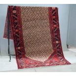 Persian runner carpet, central lozenge with geometric patterning surrounded by a red border 3.15m by