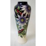 A modern Moorcroft pottery vase of baluster form, tubeline decorated in the Star of Mikan design