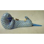 Herend Hungary, a hand painted porcelain model of a seal on its back devouring a clam, 18cm long