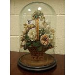 A Victorian cut fabric, wicker and dried flower diorama as a basket of flowers under a glass dome,