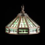 AN ARTS AND CRAFTS STAINED OAK FRAMED GREEN AND RED STAINED GLASS CHANDELIER, 20TH CENTURY, of