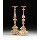 A PAIR OF ITALIAN BAROQUE PARCEL GILT AND SILVER LEAFED CARVED WOOD PRICKET CANDLESTICKS, 18TH/