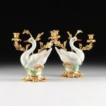 A PAIR OF ROCOCO STYLE GILT BRONZE MOUNTED POLYCHROME PAINTED PORCELAIN SWAN FORM TWO LIGHT