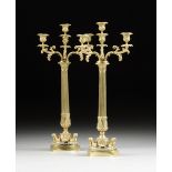 A PAIR OF REGENCY STYLE LACQUERED GILT BRASS FOUR LIGHT CANDELABRA, each with a reeded columnar stem