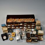 Chronometer Parts, Watch Movements, and Supplies, a twenty-one-drawer wooden cabinet with glass