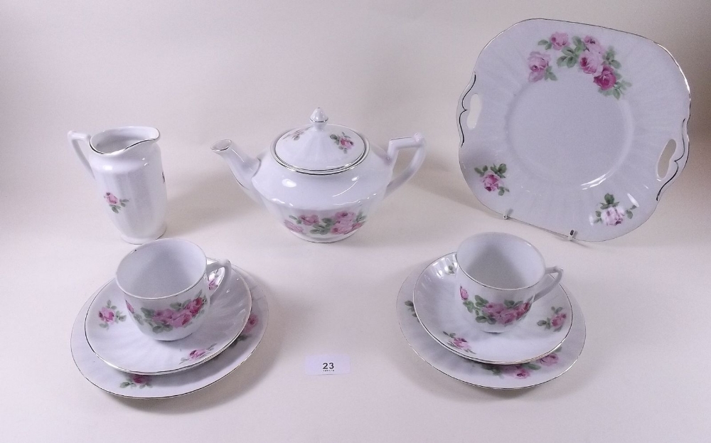 A Czechoslovakian tea set with rose printed decoration comprising:- twelve cups and saucers,