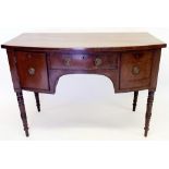 An early 19th century mahogany sideboard with frieze drawers flanked by cellarette drawer and