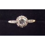 An Edwardian gold ring claw set diamond on diamond set shoulders