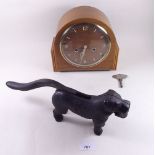 A 1950's walnut striking mantel clock and a Victorian iron dog nutcracker