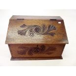 A Victorian oak slope top correspondence box with carved decoration