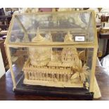 An Indian carved wood model of a temple in glass case