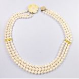 A freshwater pearl three strand necklace