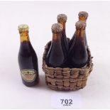 Four Guinness miniature bottles in a basket and another miniature bottle