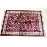 A Kashmir rug with red ground and all over floral design - 1.7 x 1.2m