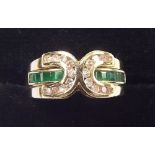 A 14 carat gold metamorphic ring with two diamond set curves and removable emerald set centre band