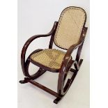 A child's cane rocking chair