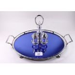 A 1920's silver plated and blue mirrored glass tray and a silver plated cruet set